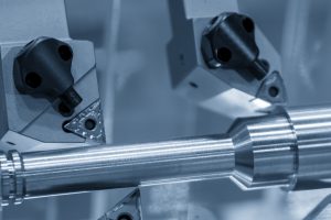 A close up image of a CNC machine working on a metal part.