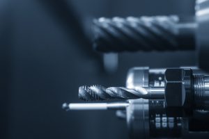 A close-up image of drill and lathe parts for a CNC machine.