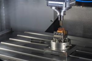 CNC milling machine at work on copper component